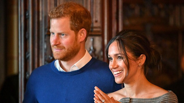 Prince Harry and Meghan Markle watch a performance by a Welsh choir in the banqueting hall during a visit to Cardiff Castle on January 18, 2018 in Cardiff, Wales