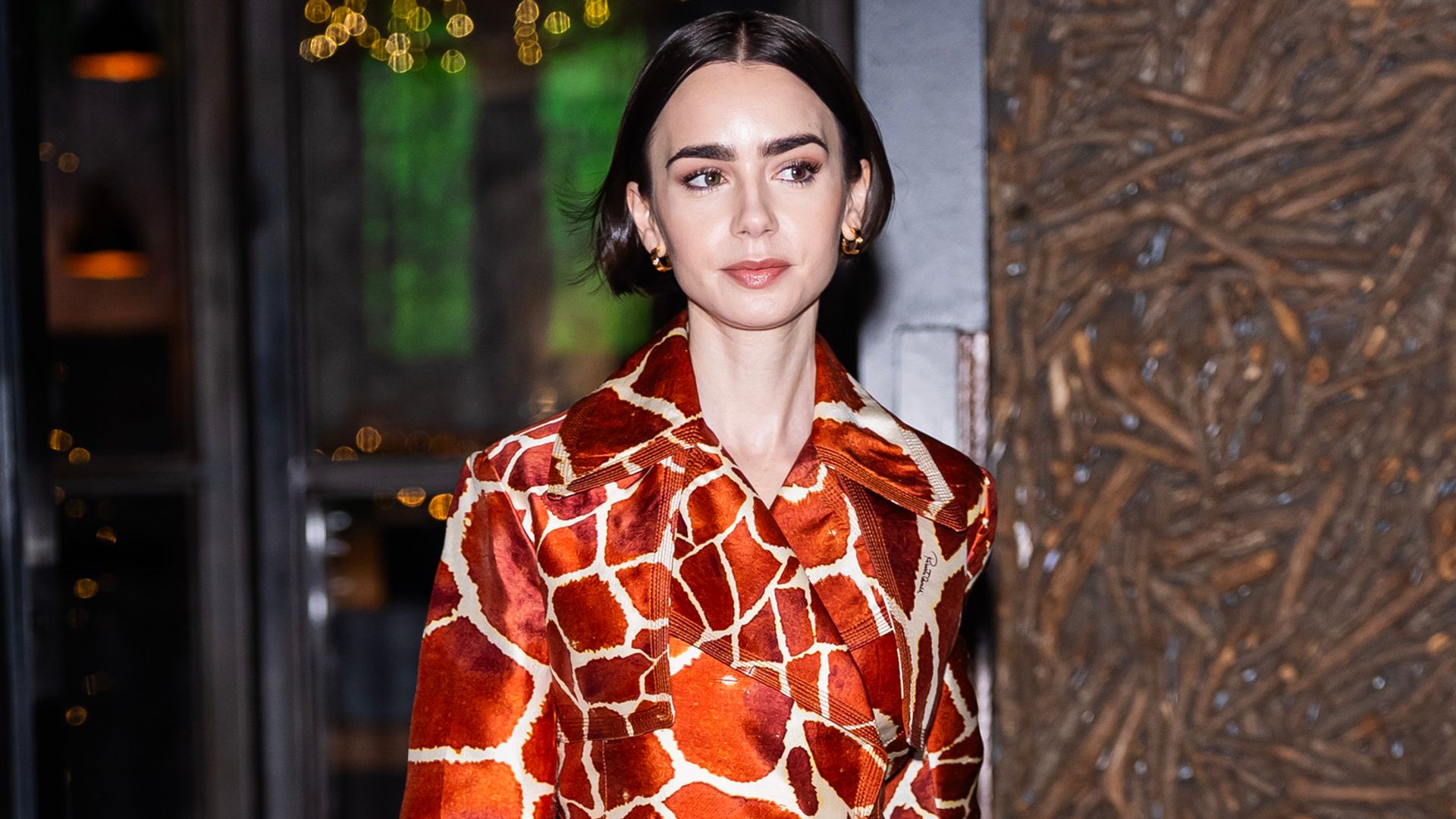 Lily Collins is seen in Midtown in giraffe print coat