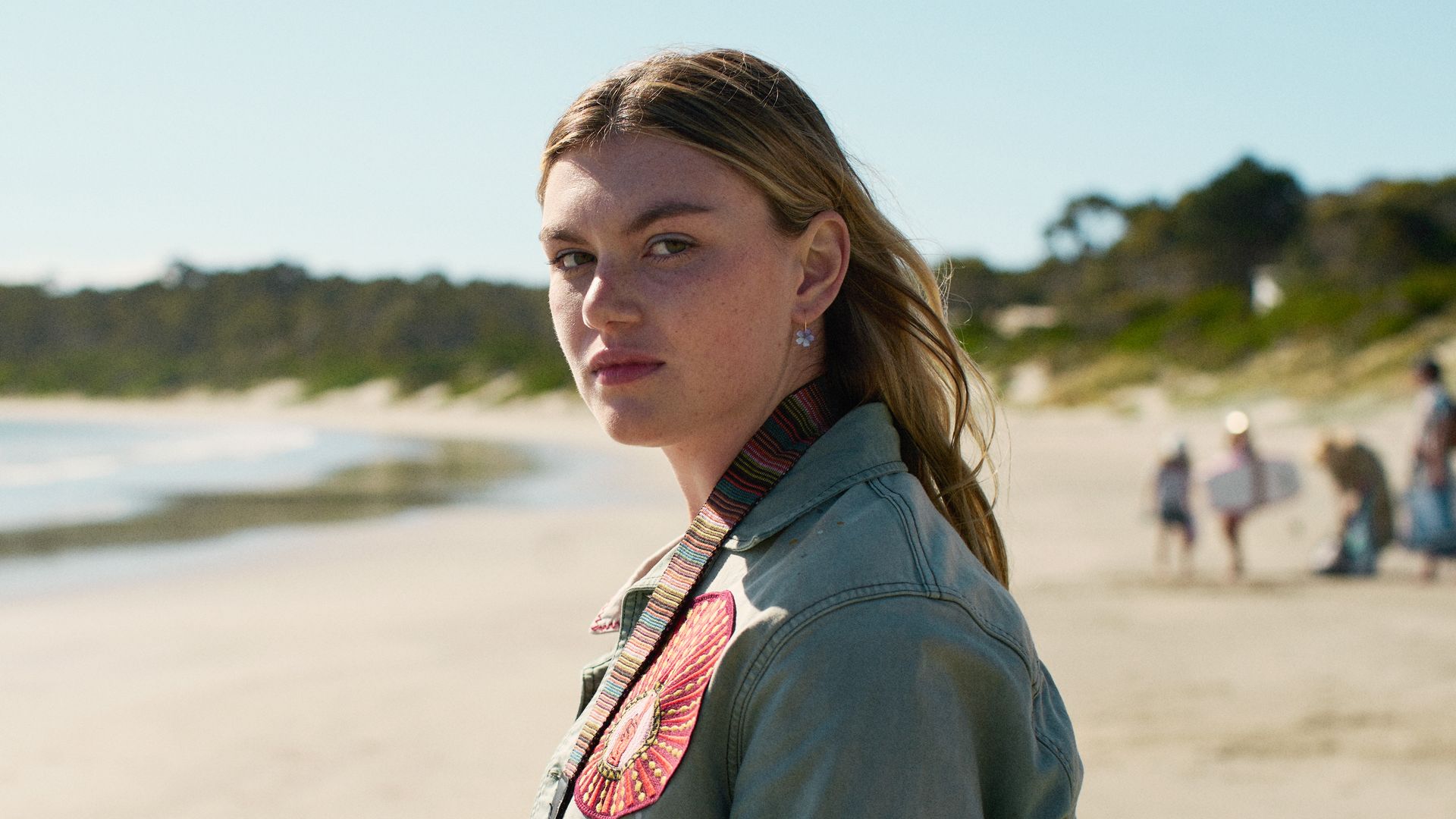 young woman standing on beach close-up