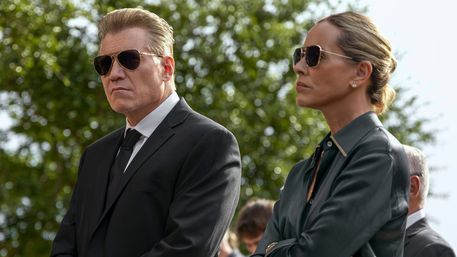 man and woman dressed in black clothing wearing shades