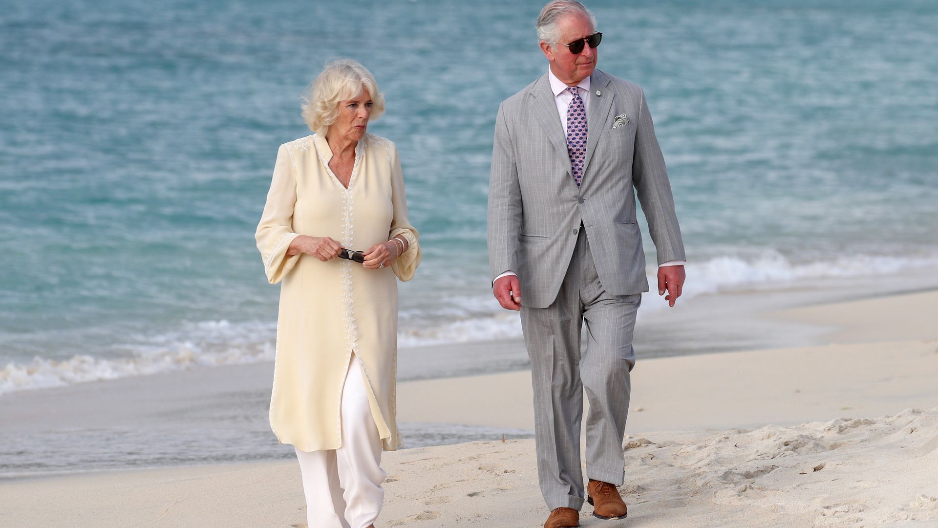 charles and camilla walking along beach