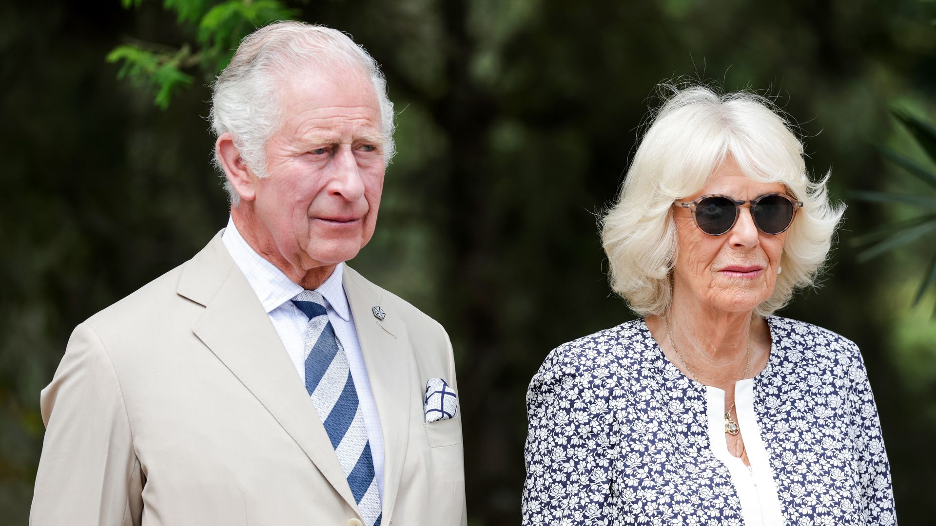 King Charles and Queen Camilla look solemn
