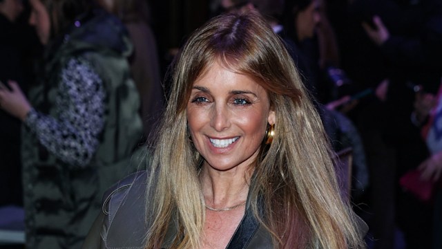 Louise Redknapp smiling in a leather jacket