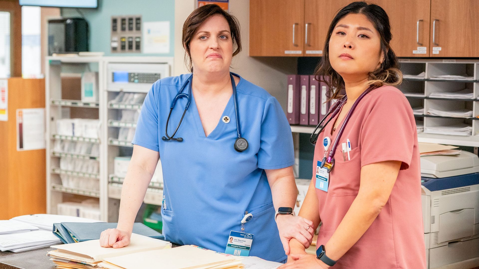 two nurses standing at hospital reception