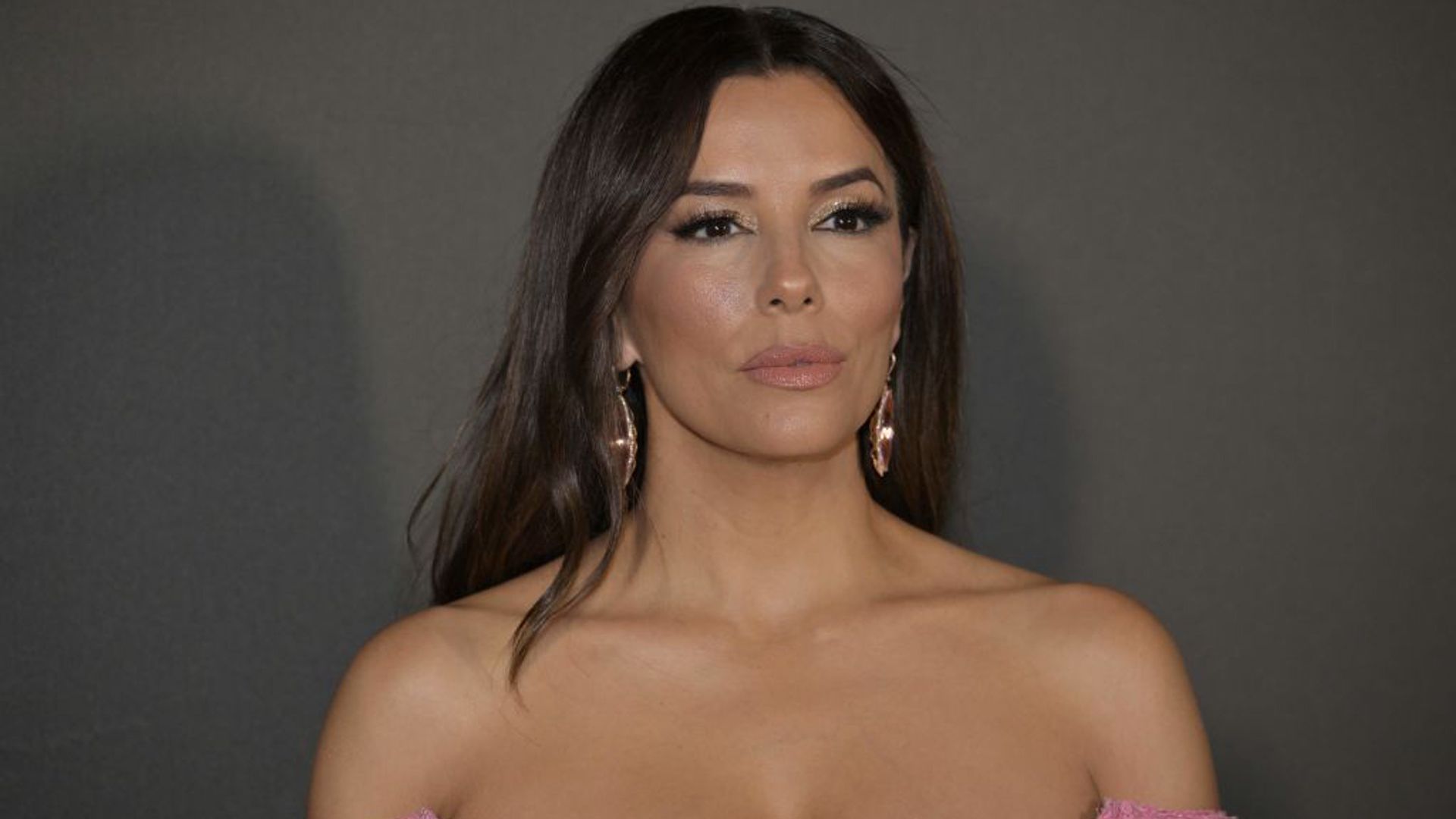Eva Longoria poses at Cannes in a pink bardot gown
