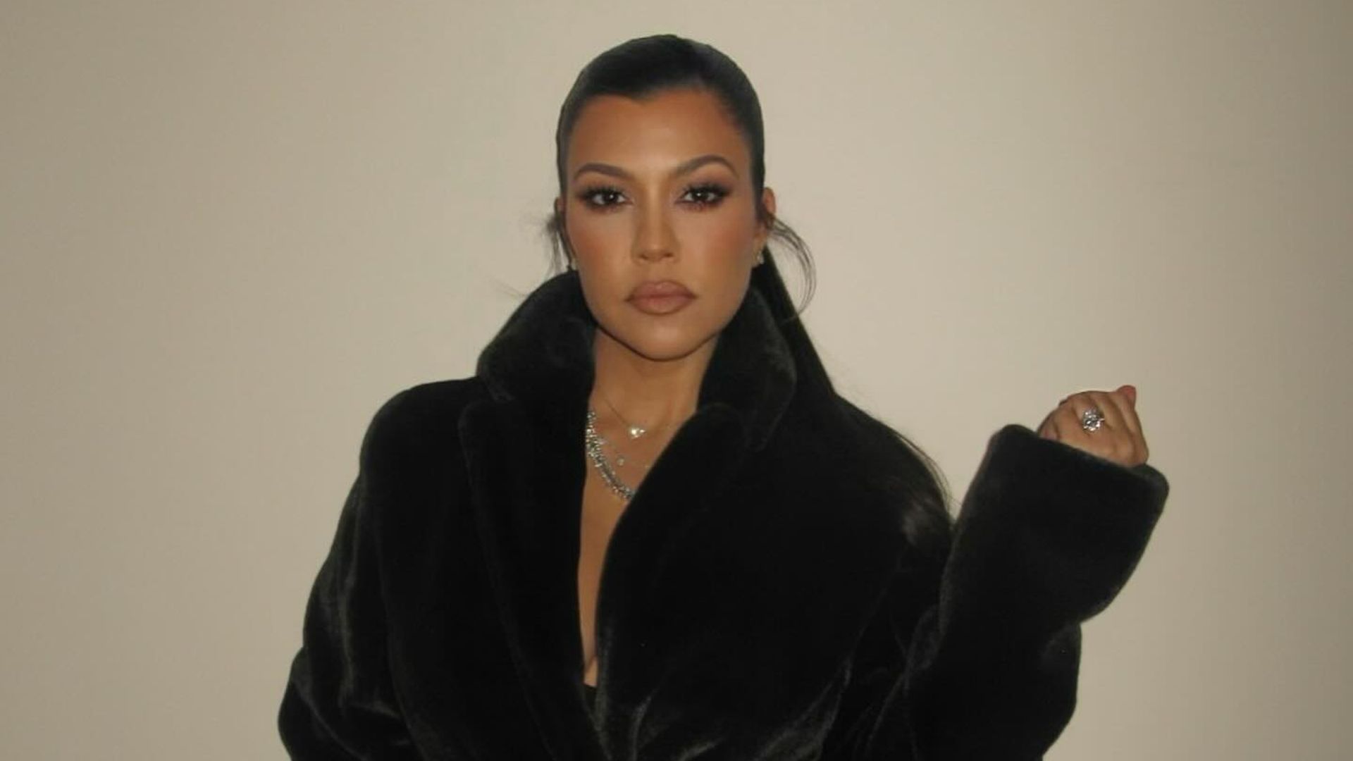 Kourtney Kardashian in fur coat and tights