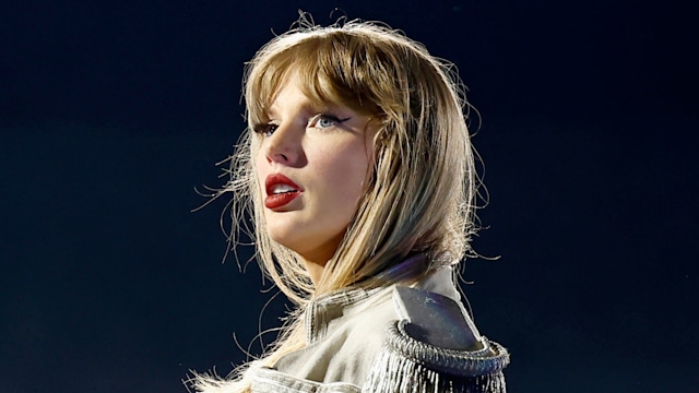 Taylor Swift on stage in a white military jacket