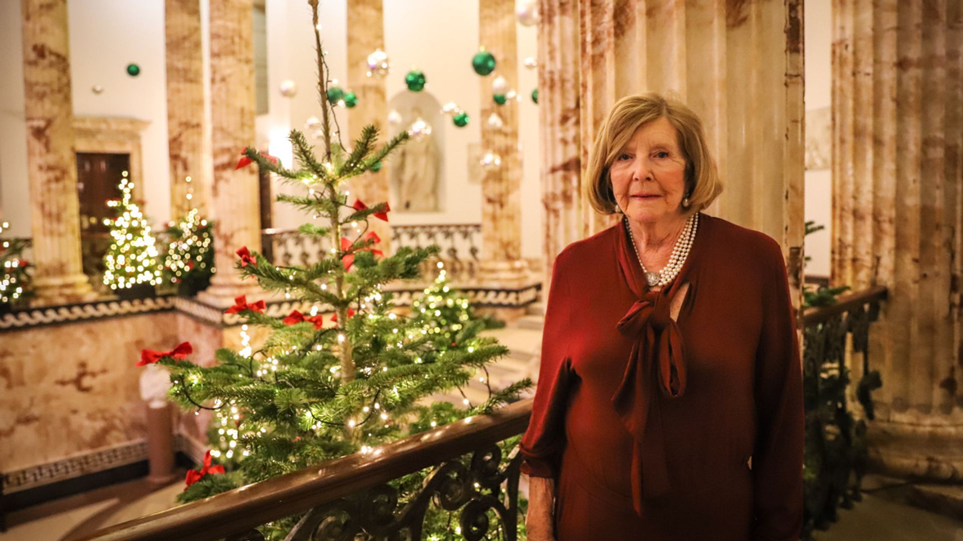 Lady Anne Glenconner in front of Christmas tree at Holkham Hall