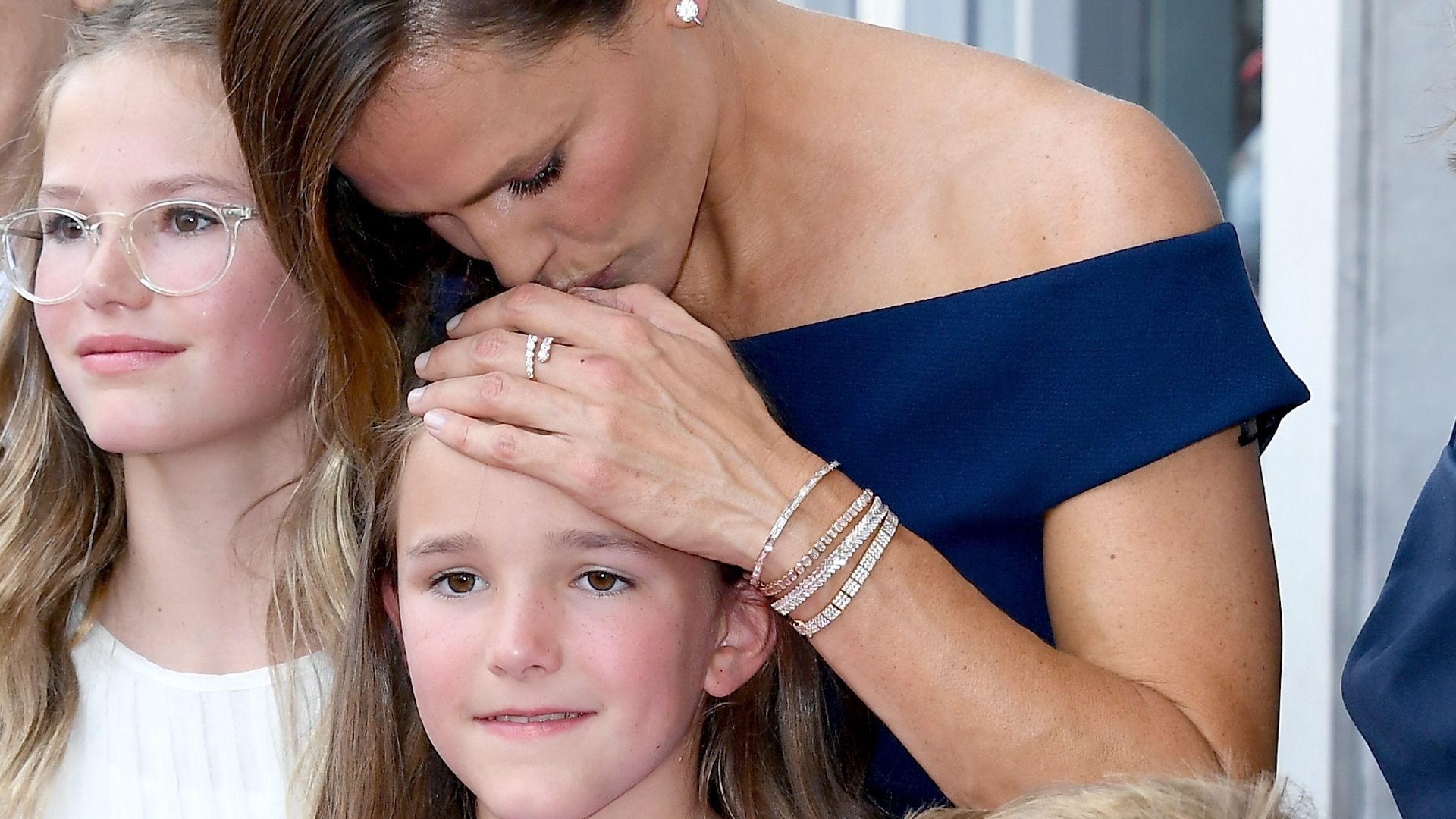 Jennifer kisses her child Fin on the head in adorable family photo