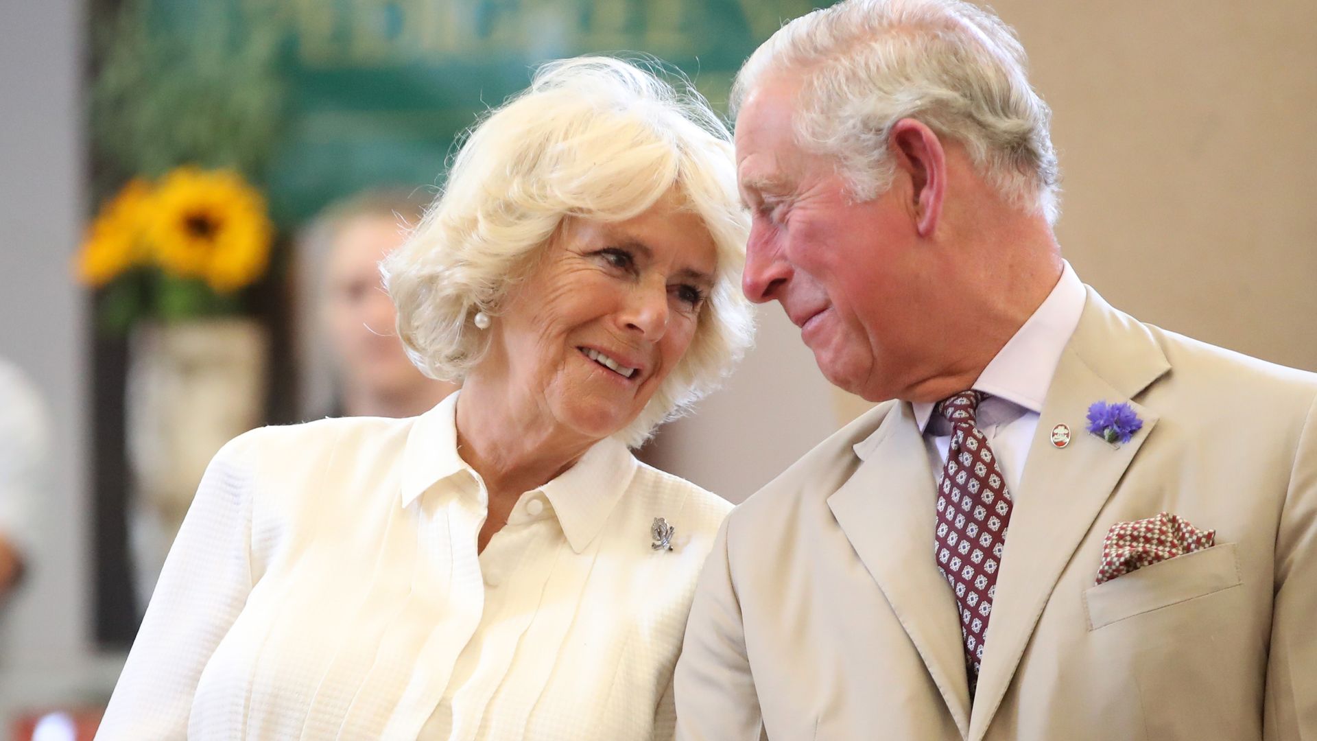 Queen Consort Camilla and King Charles gazing at each other lovingly at a public engagement