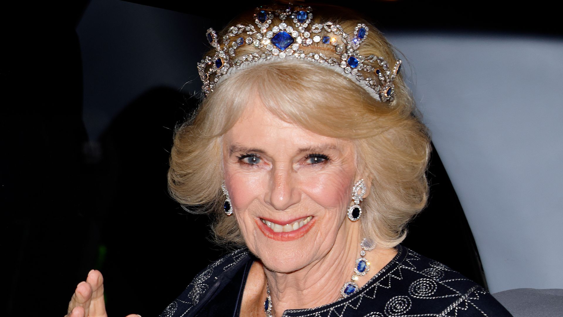Camilla Queen Consort waving in a crown