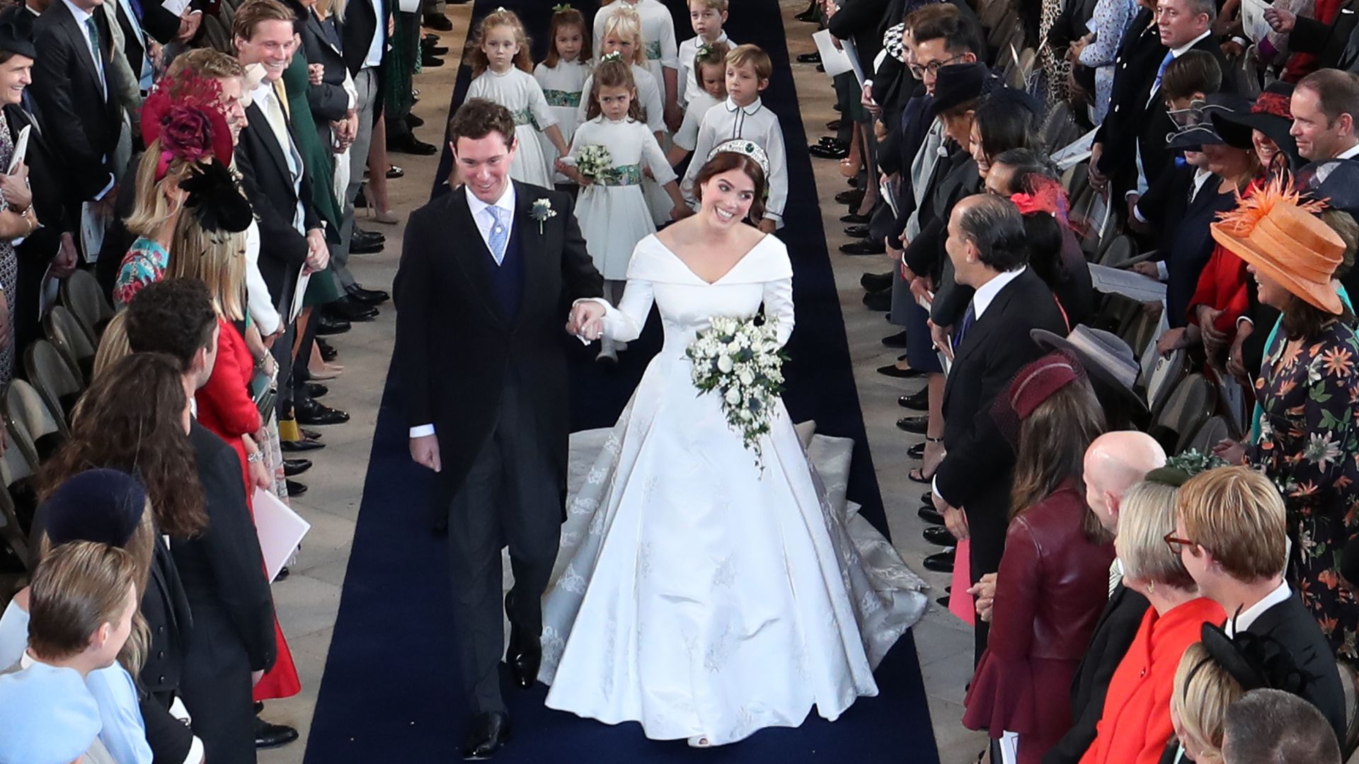 Princess Eugenie of York and Jack Brooksbank walk down the aisle following their marriage at St George's Chapel in Windsor Castle