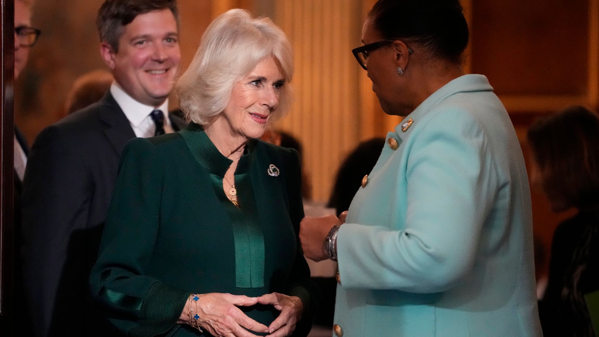 Queen Camilla, 76, is a vision in green as she meets women leaders at domestic violence event