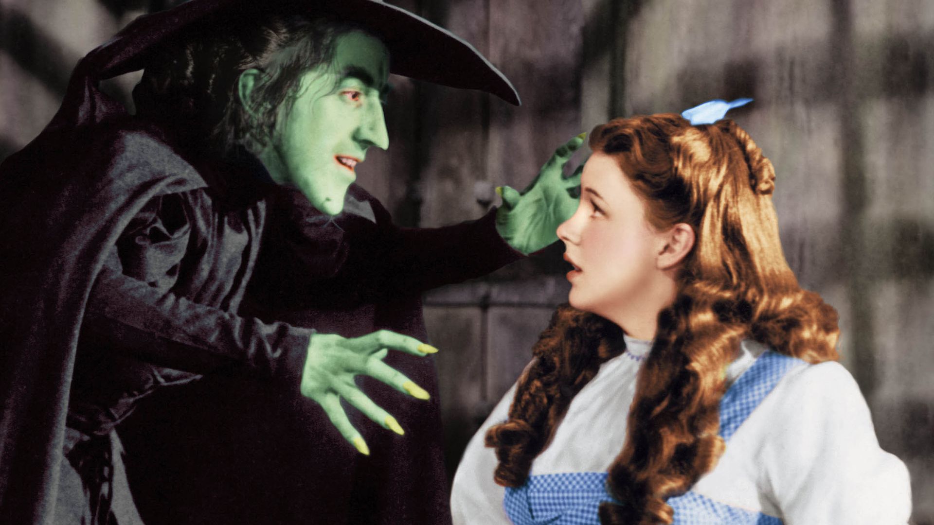 A close-up image of Judy Garland and Margaret Hamilton in the Wizard of Oz
