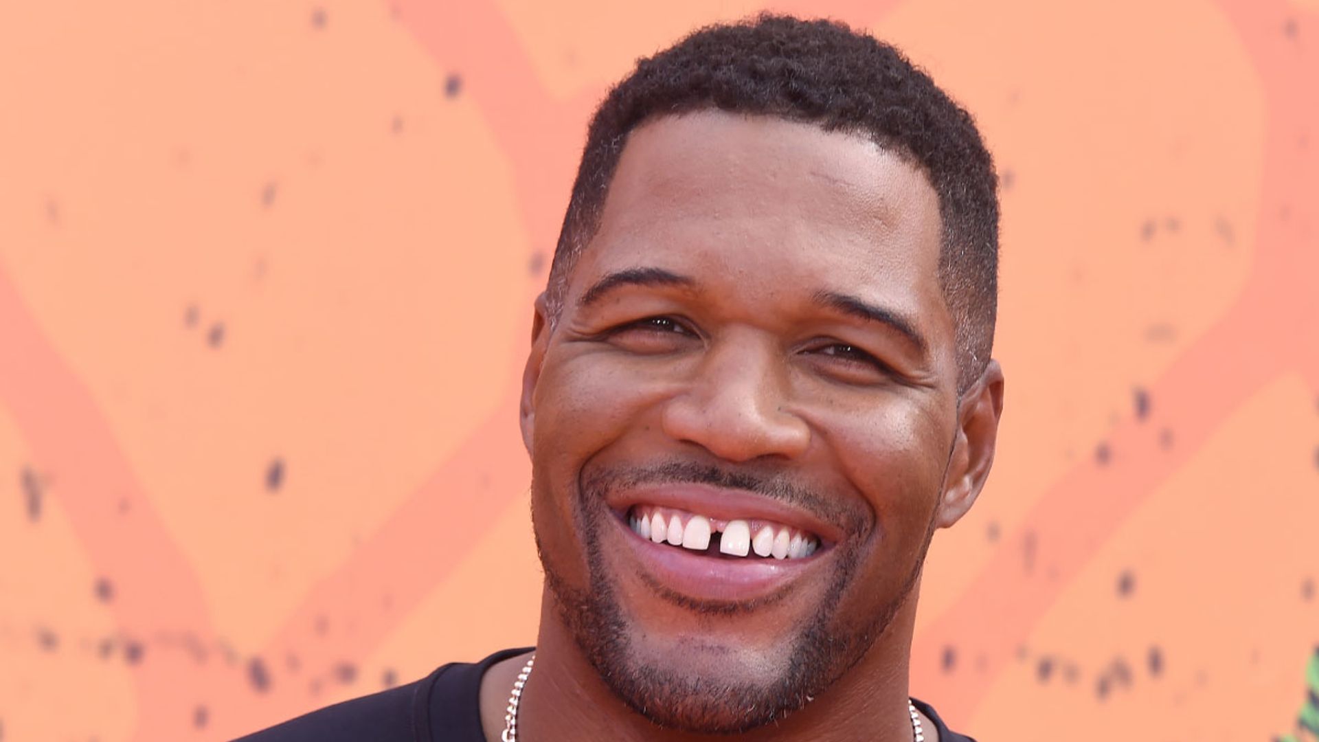 Michael Strahan smiles broadly in photo on red carpet
