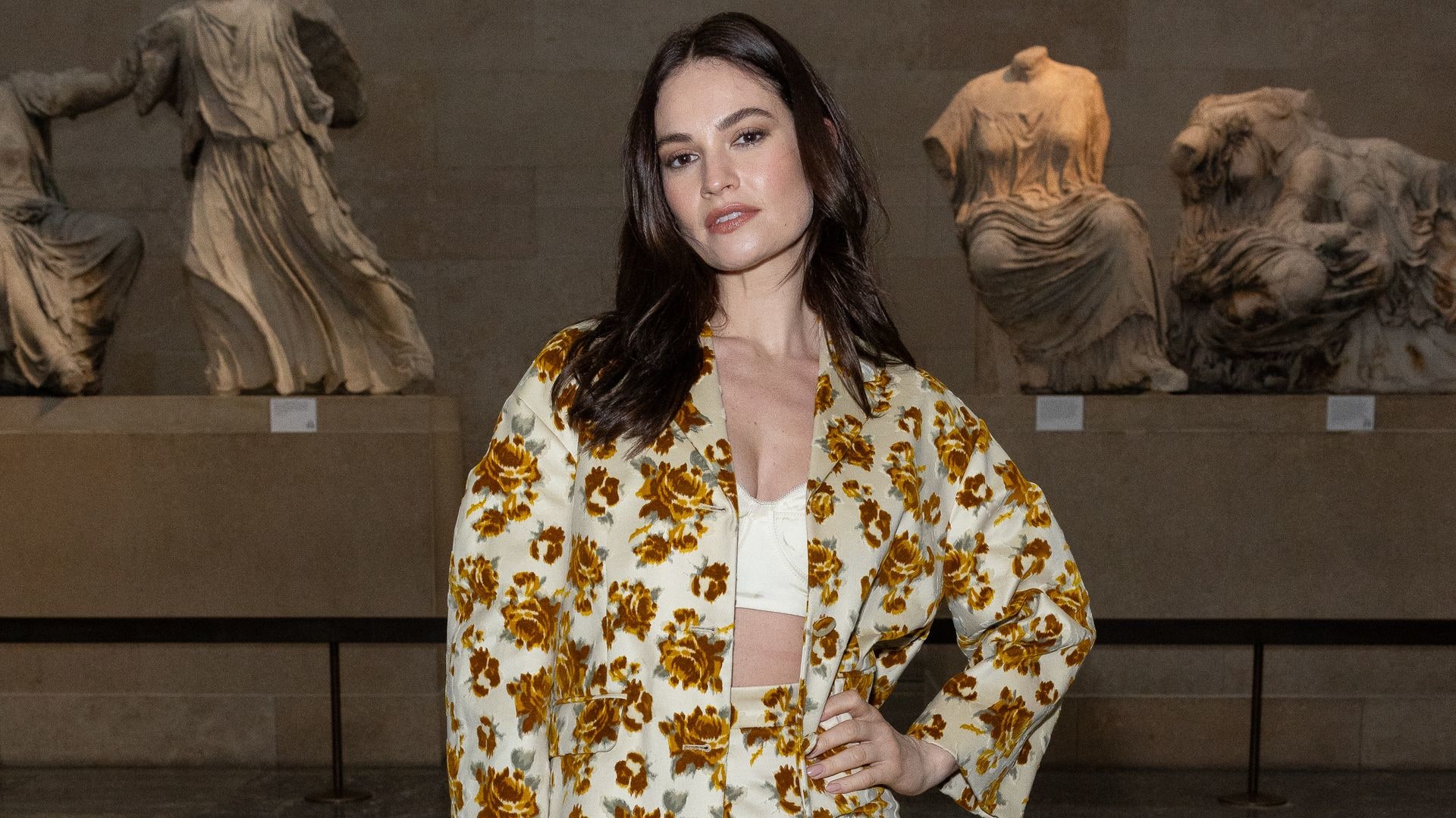 Lily James at Erdem RTW Fall 2024 show in a floral two piece skirt and jacket combo