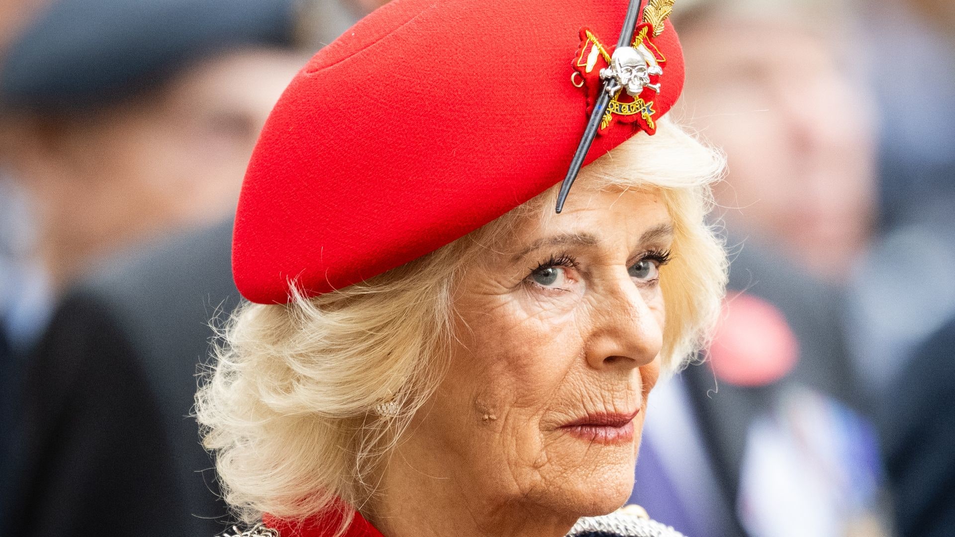 Queen Camilla in military beret and navy coat