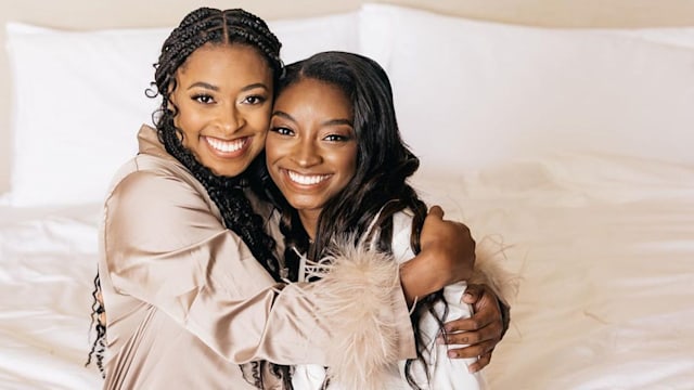 Simone and her sister Adria wearing cream tones and grinning