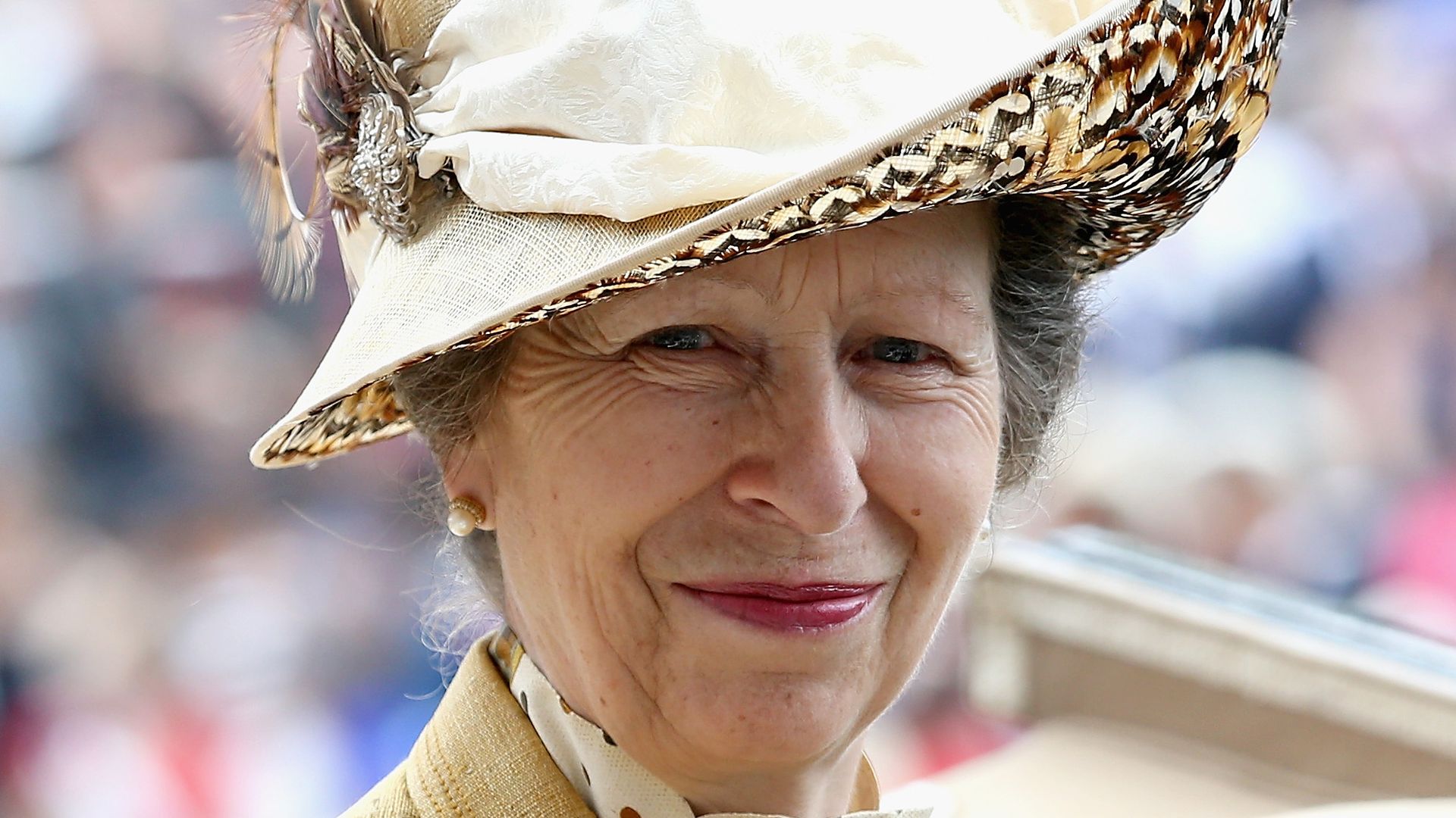 Princess Anne in yellow and gold hat