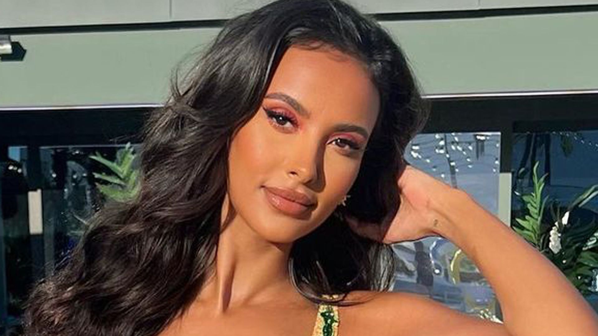 Maya Jama poses for photo as the sun shines on her face