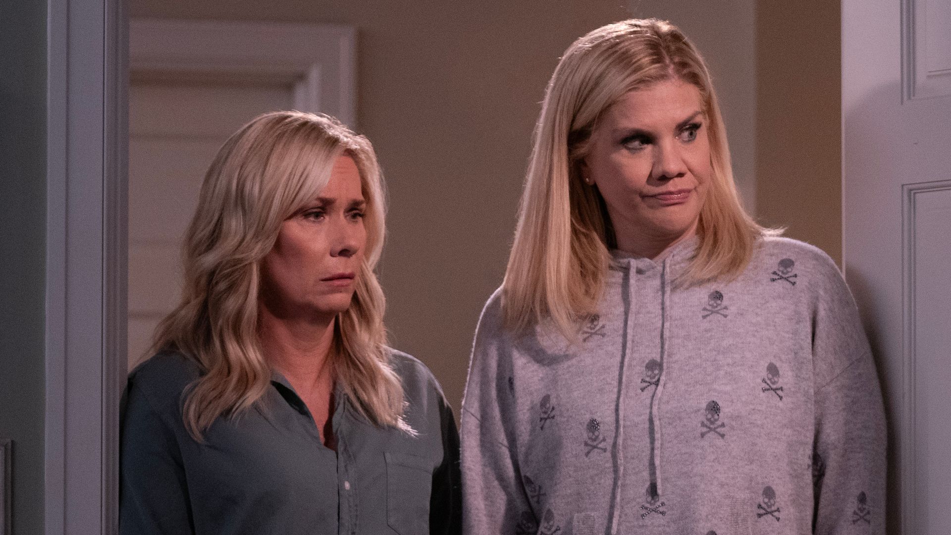 two women standing in house doorway