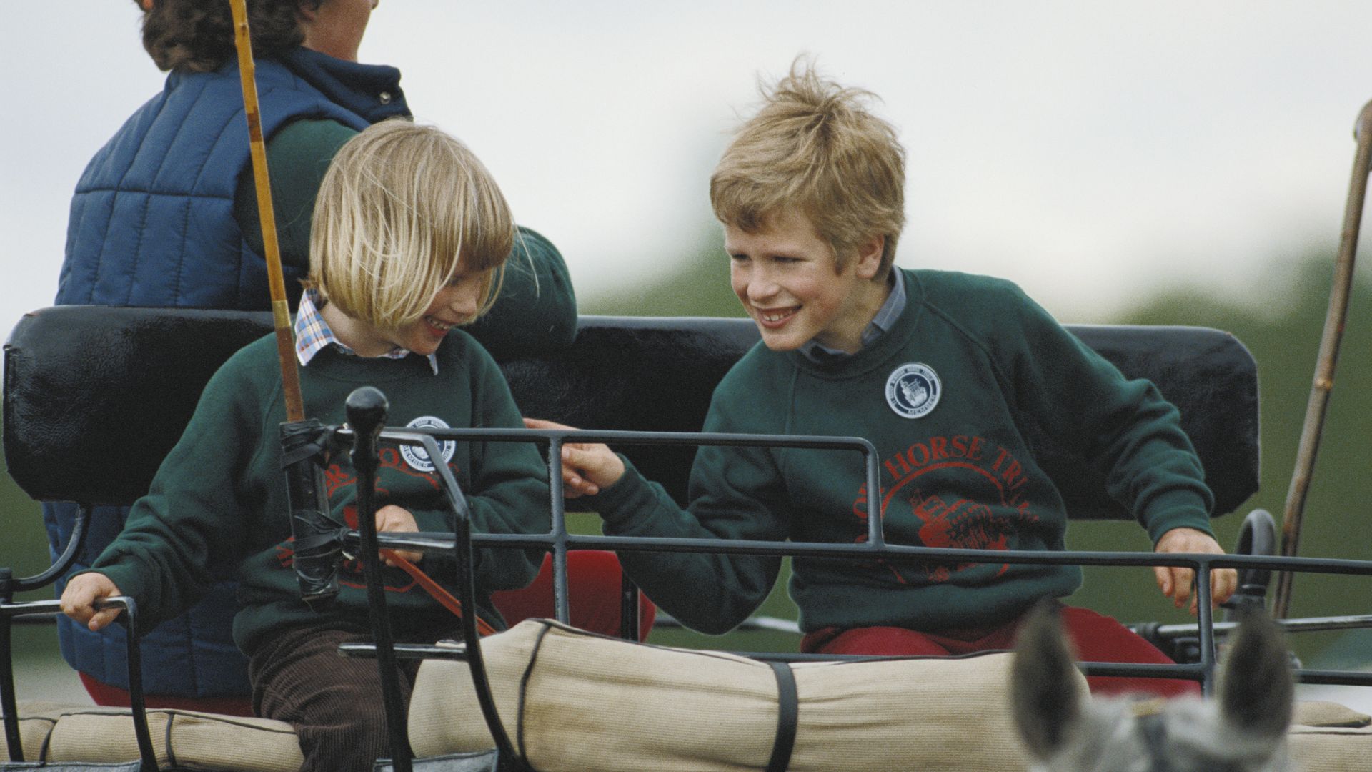 zara and peter riding in carriage at horse show