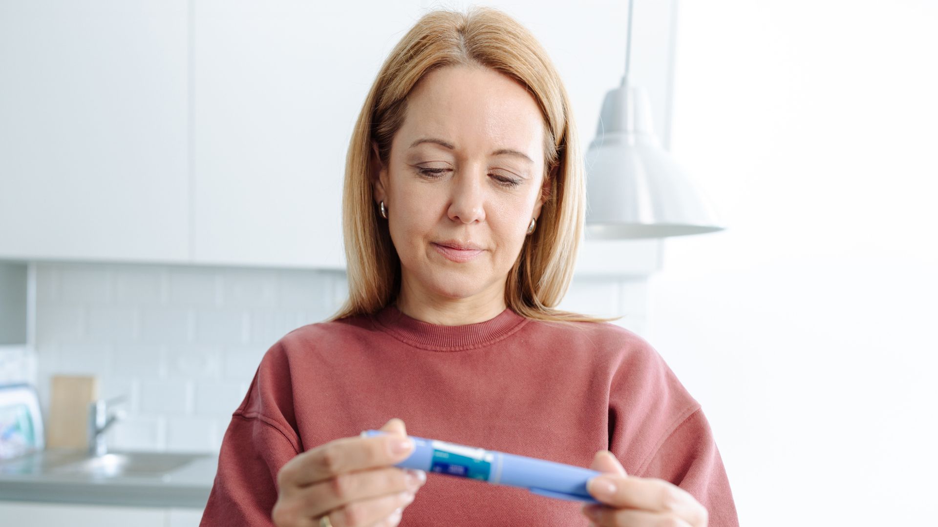 woman holding ozempic pen