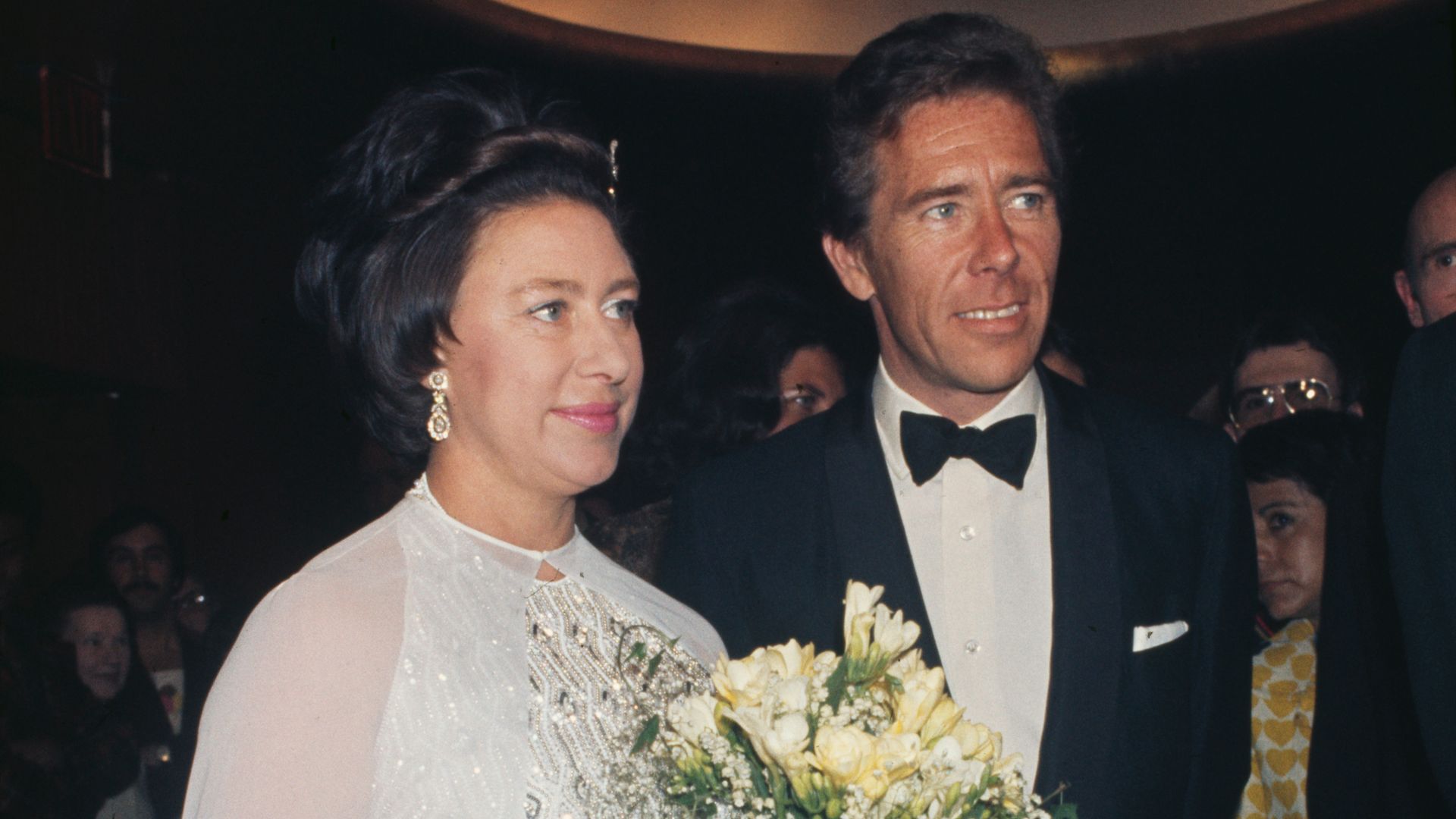 Princess Margaret holding a bouquet of flower standing next to Antony Armstrong-Jones