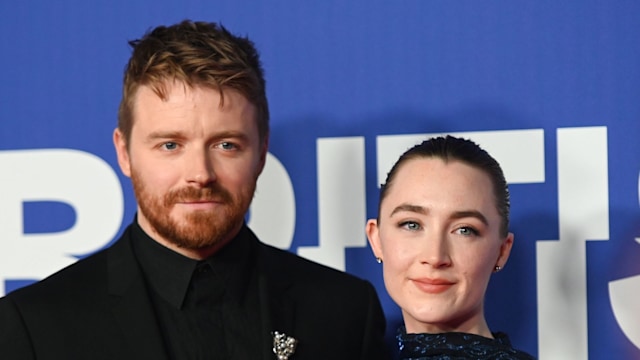 couple smiling on red carpet