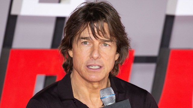 Tom Cruise at Mission: Impossible event holding microphone