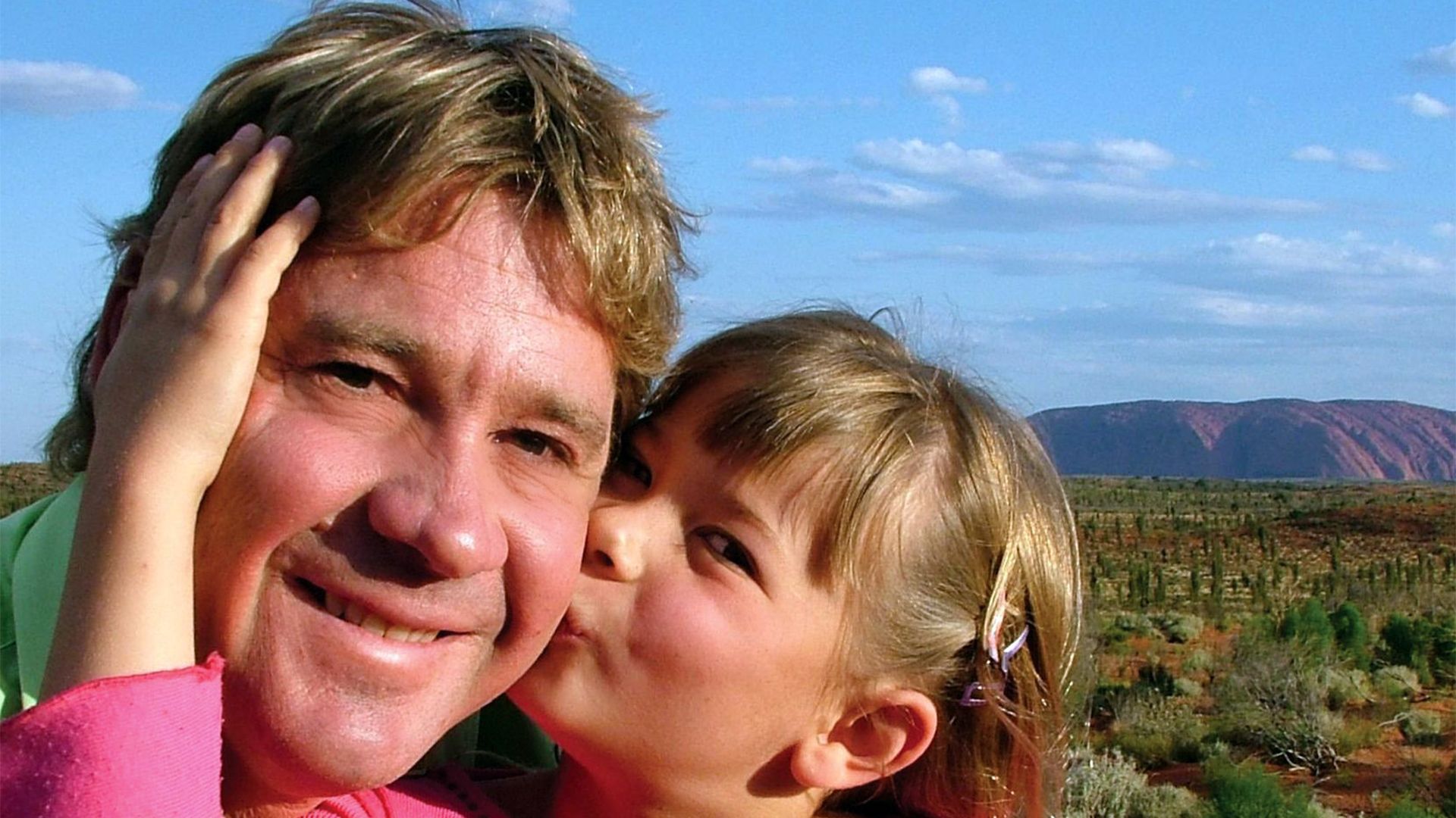 Young Bindi Irwin kisses her dad Steve Irwin's cheek as they enjoy the sunshine
