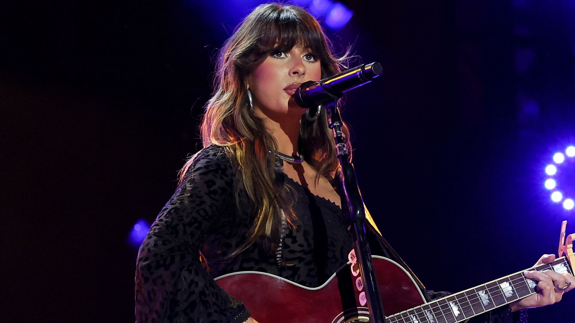 ella langley with guitar on stage