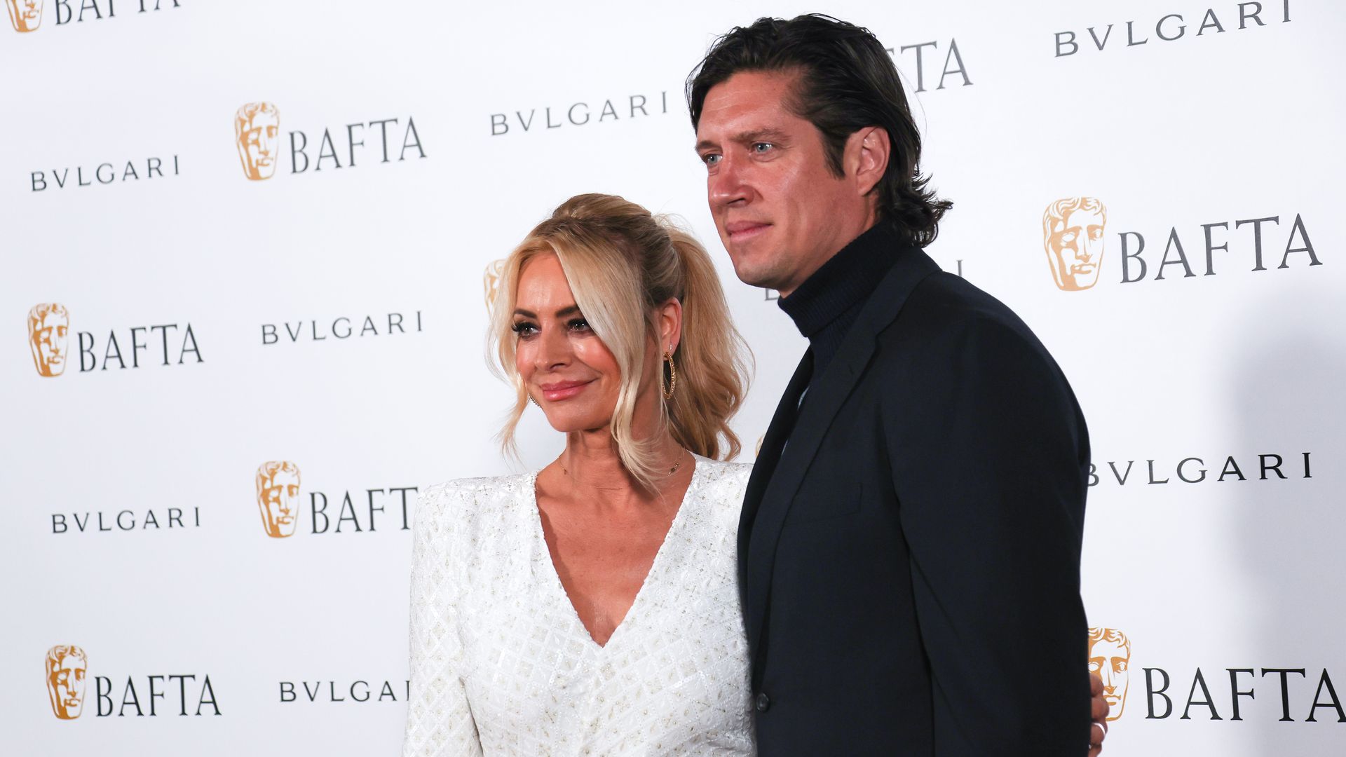 Tess Daly in white and Vernon Kay in black on red carpet