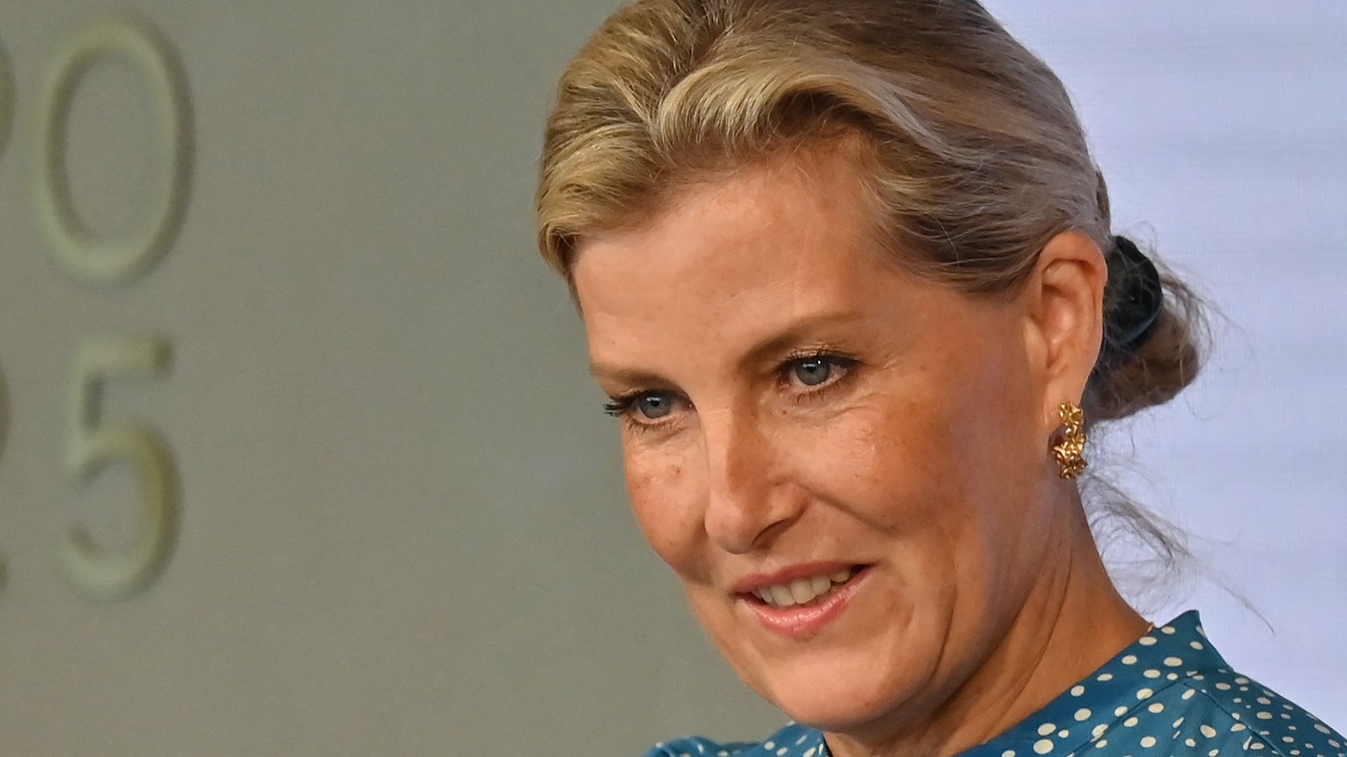 Sophie, Duchess of Edinburgh speaking into mic in blue dress