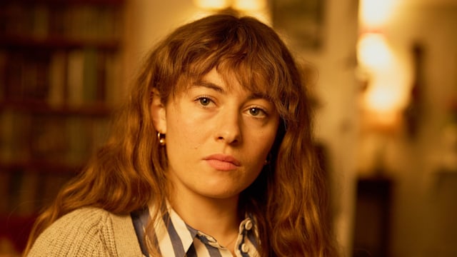woman with long brunette hair and stripe shirt 