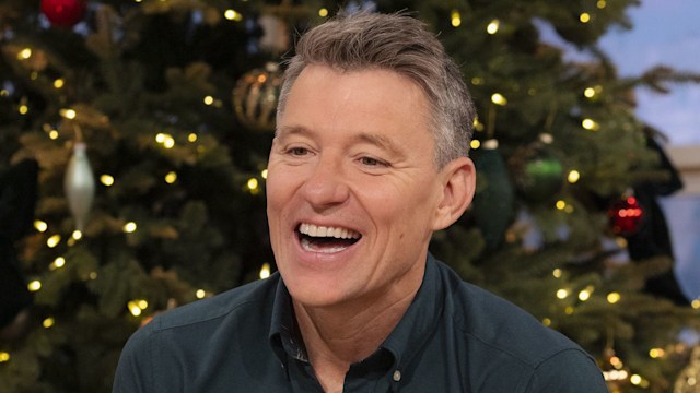 Ben Shephard smiling in front of a Christmas tree