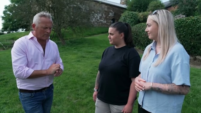 Man standing in garden with two younger women
