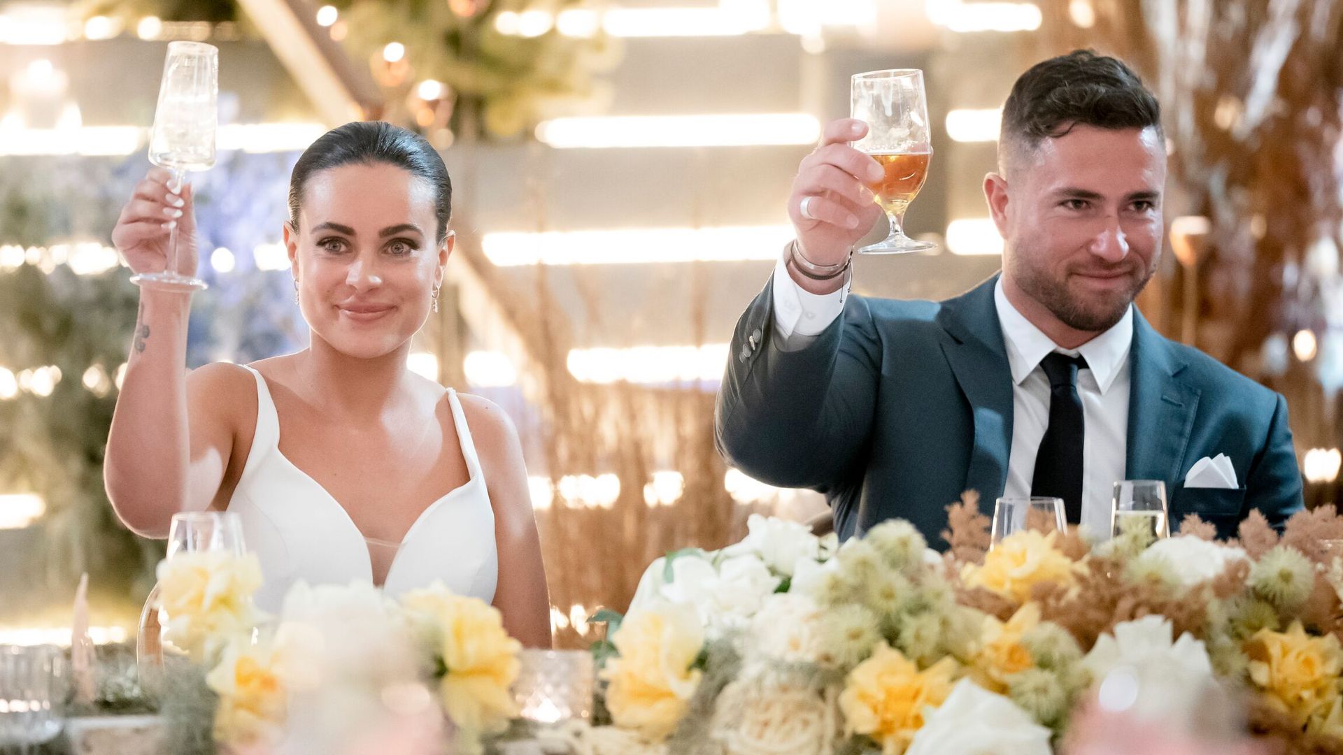 Bronte and Harrison raise glass at wedding