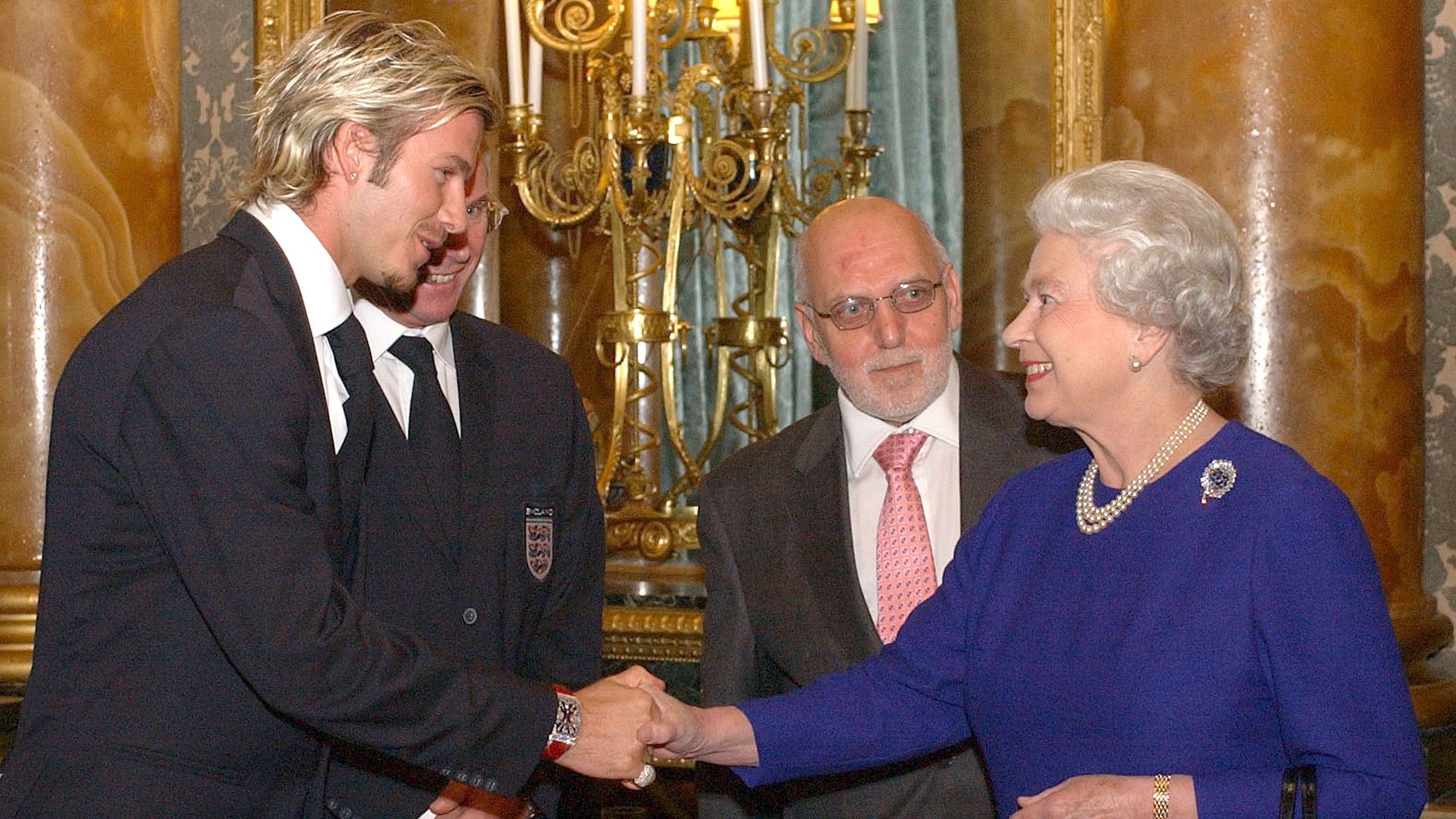 David Beckham shaking hands with the late Queen
