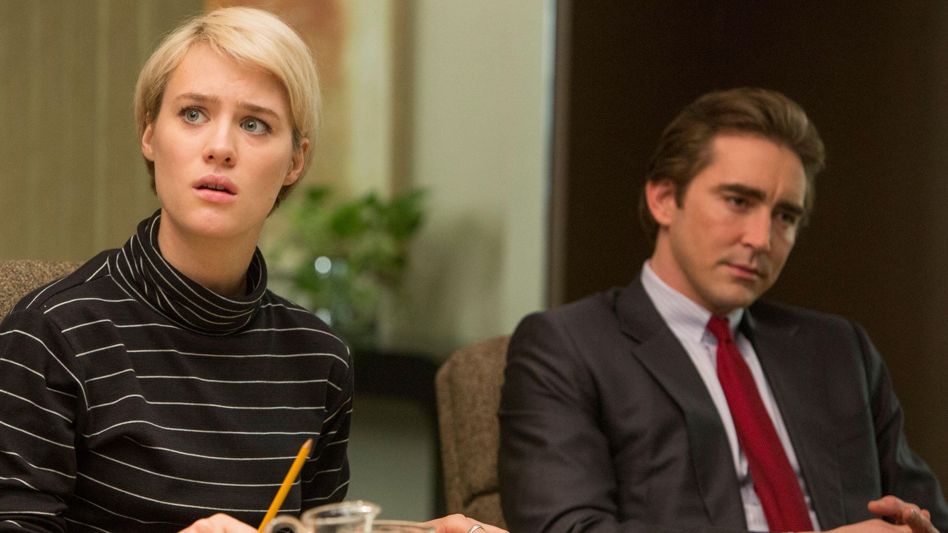 woman and man sitting at desk