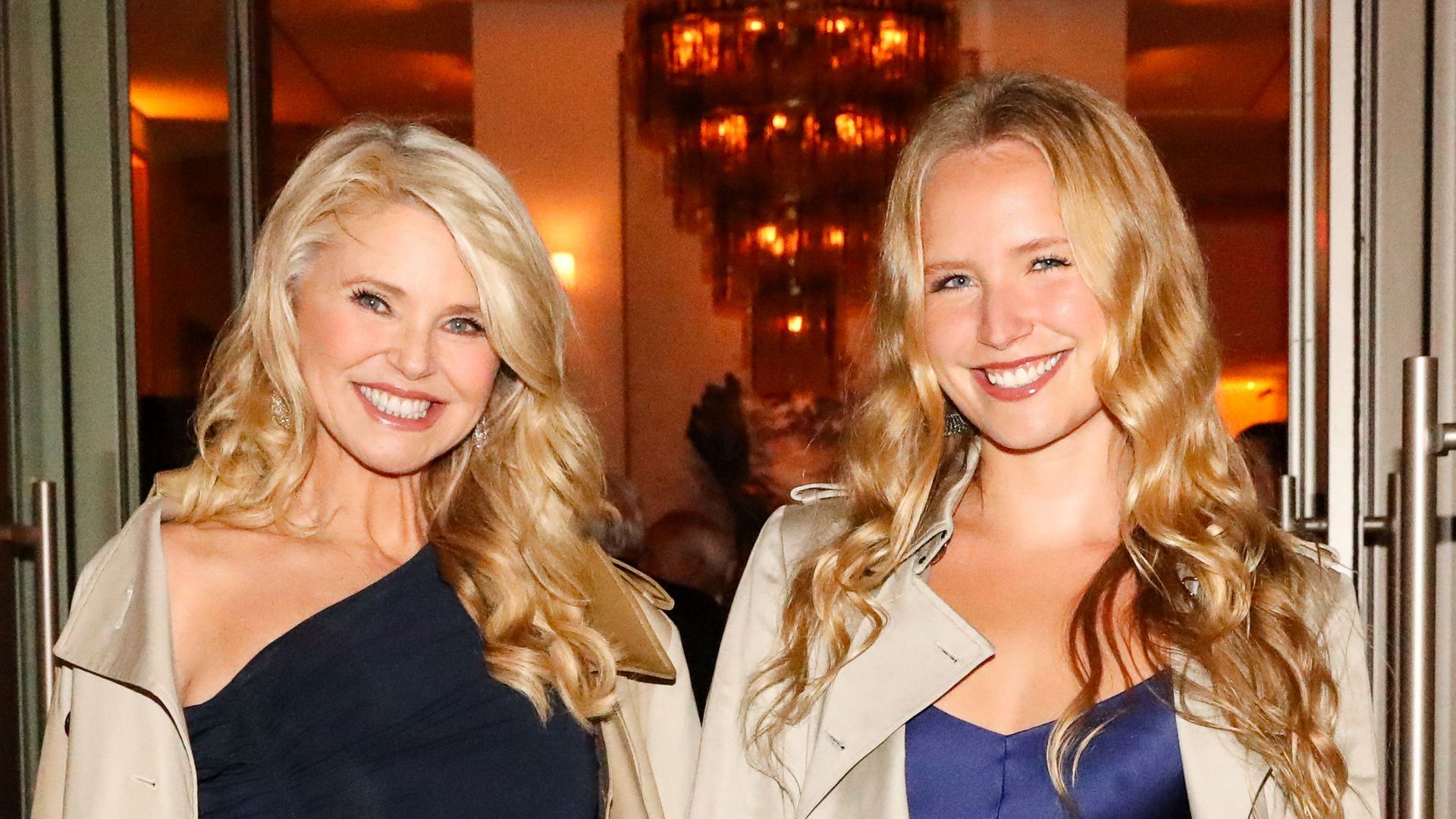 photo of christie brinkley and sailor brinkley cook smiling in blue dresses