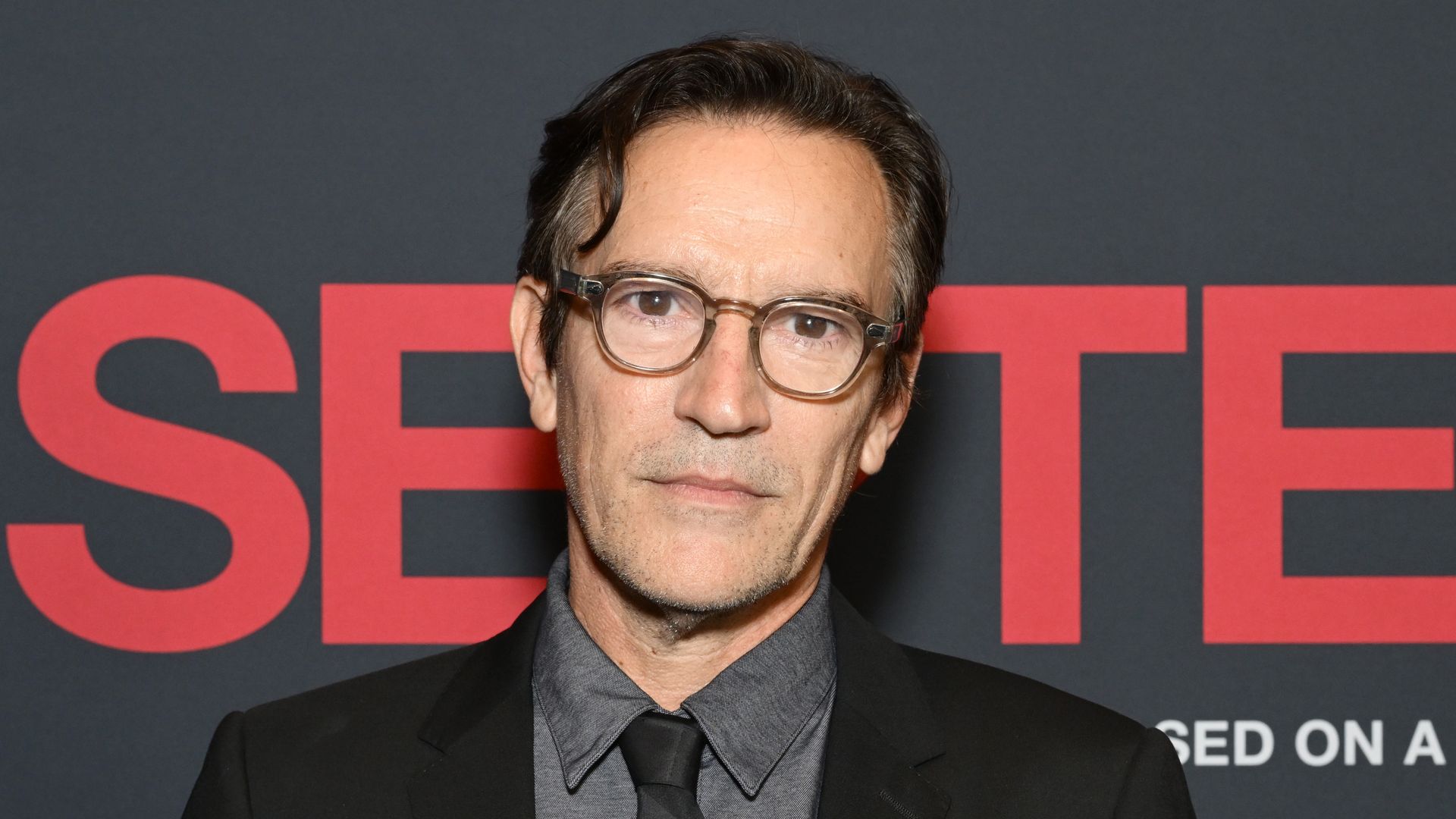 Ben Chaplin in a black suit and tie