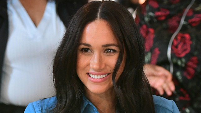 Meghan Markle wearing blue dress and smiling