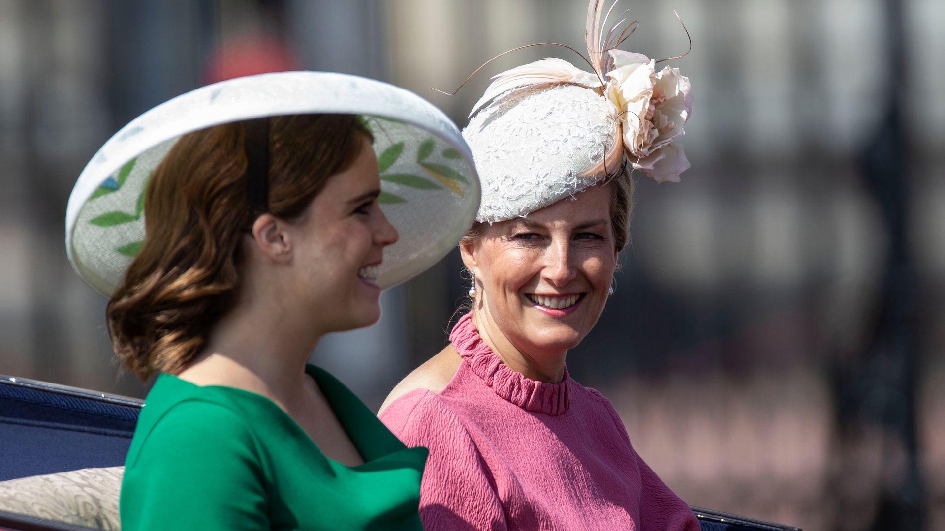 Princess Eugenie and Duchess Sophie smiling together in a carriage