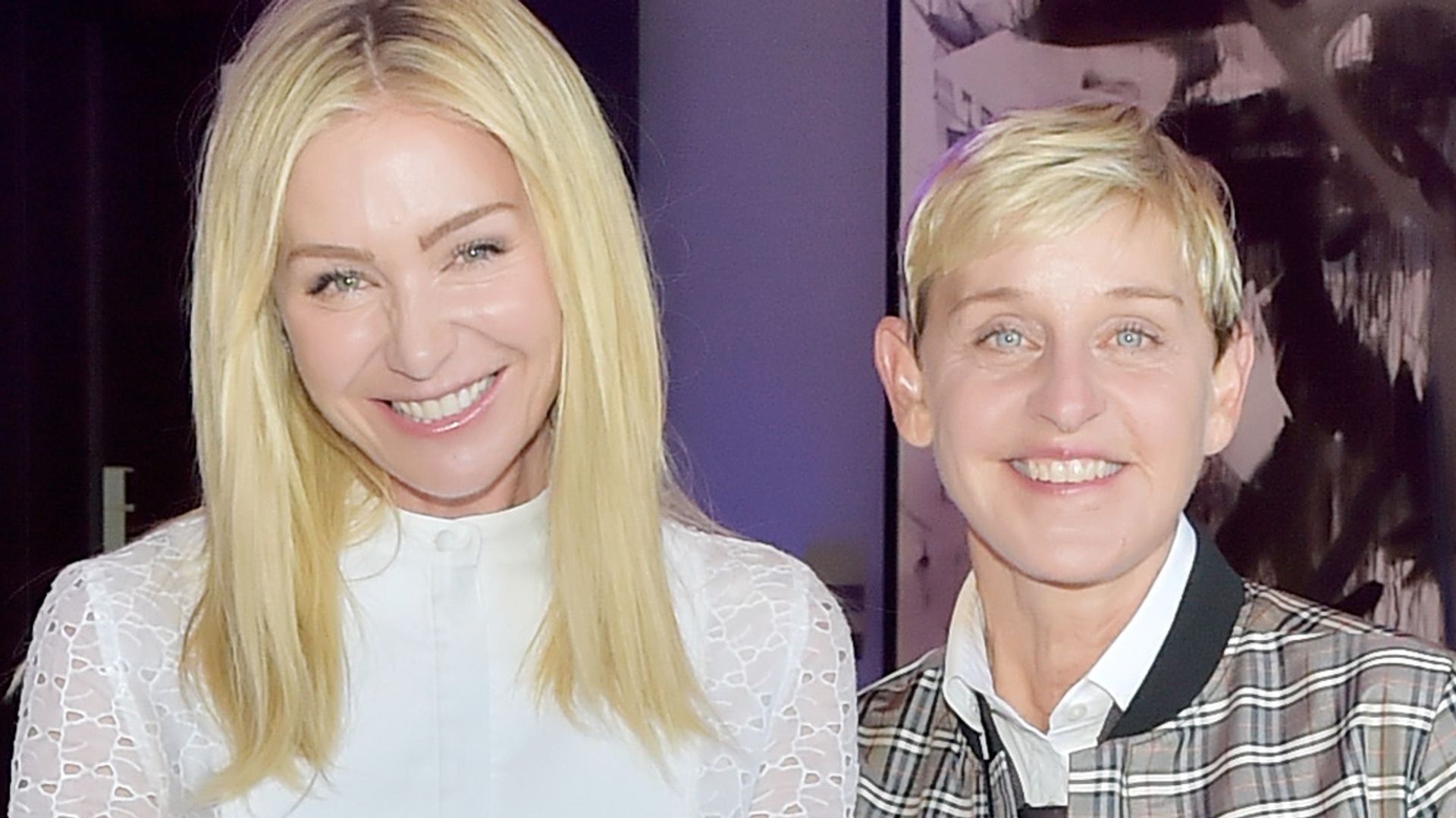 Portia de Rossi in a white outfit with Ellen DeGeneres in a checked jacket