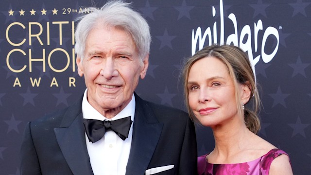 Harrison Ford and Calista Flockhart look at camera while walking on red carpet of critics choice awards