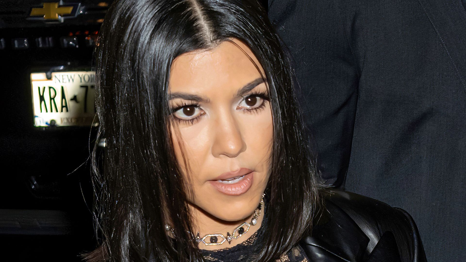 Close up of Kourtney Kardashian wearing a black leather jacket