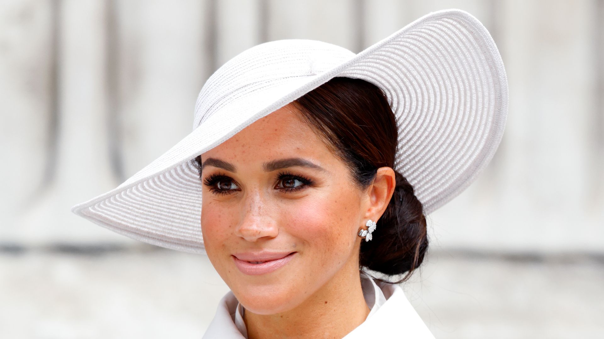 Meghan in white coat and hat