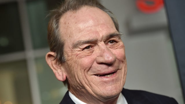 Actor Tommy Lee Jones in suit on red carpet 