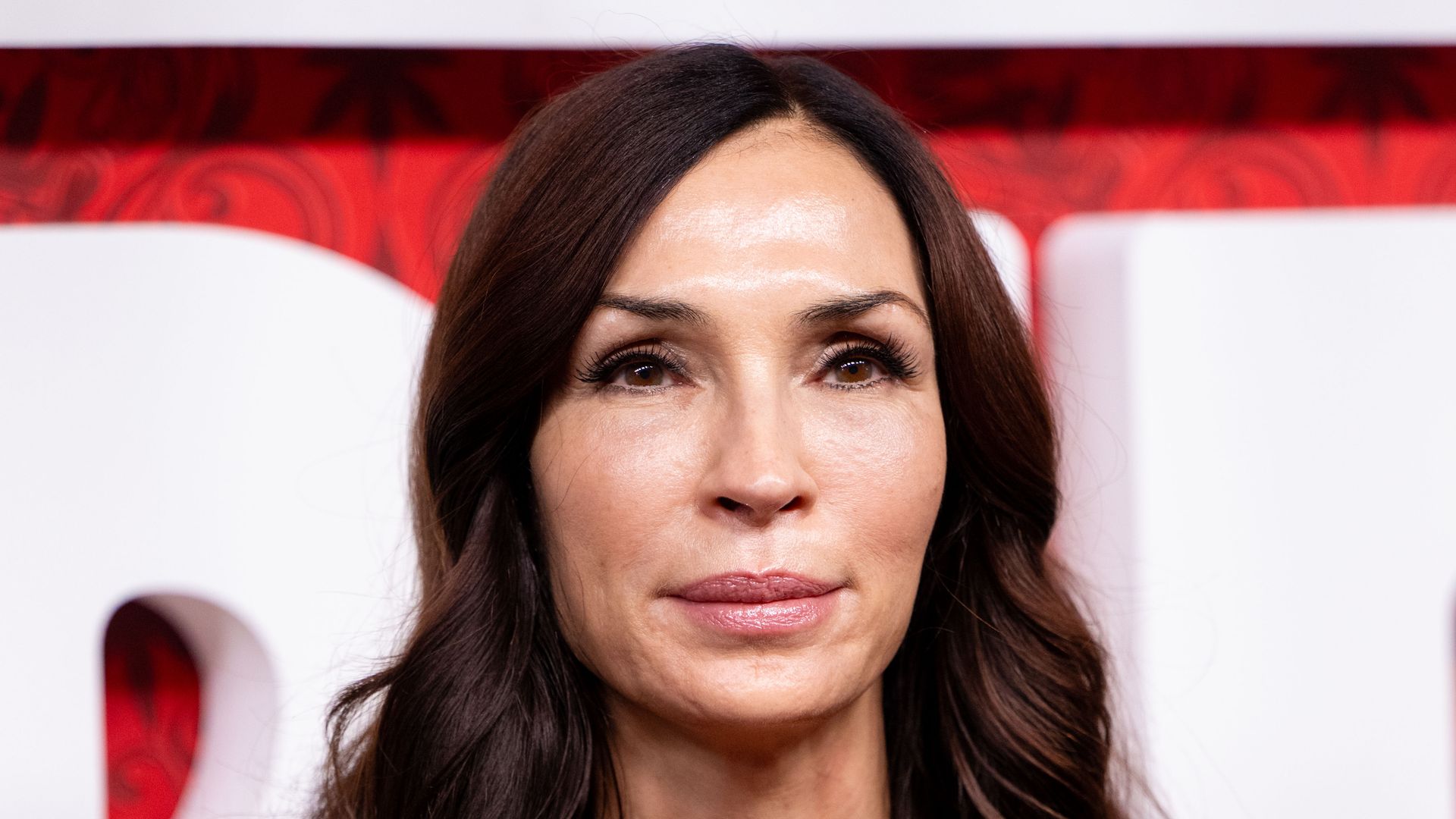 Famke Janssen red dress, smooth complexion